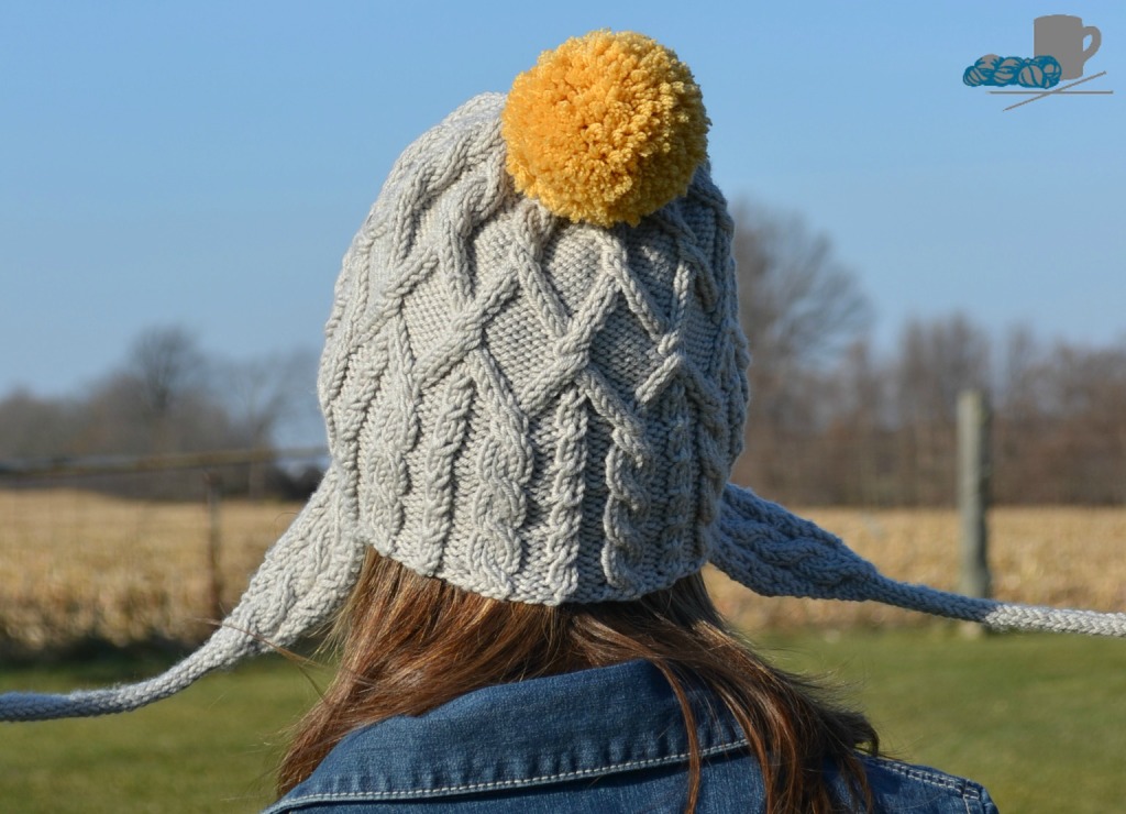 Merry cabled hat pattern with pompoms. www.aknitica.com #knitting #cables #pompoms